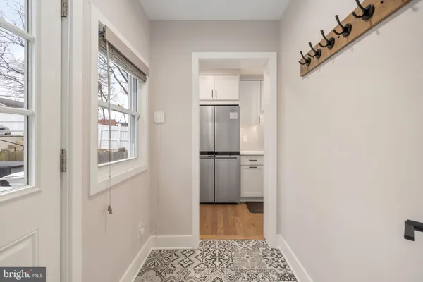 a view of a hallway with wooden floor and a cabinet