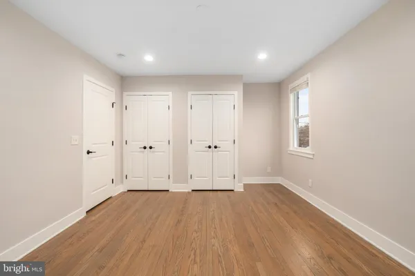 a view of room with window and wooden floor