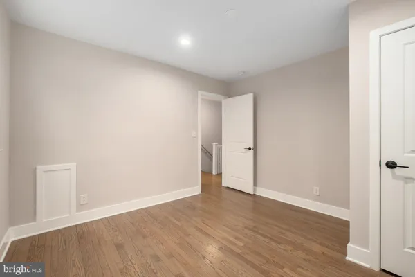 a view of an empty room with wooden floor