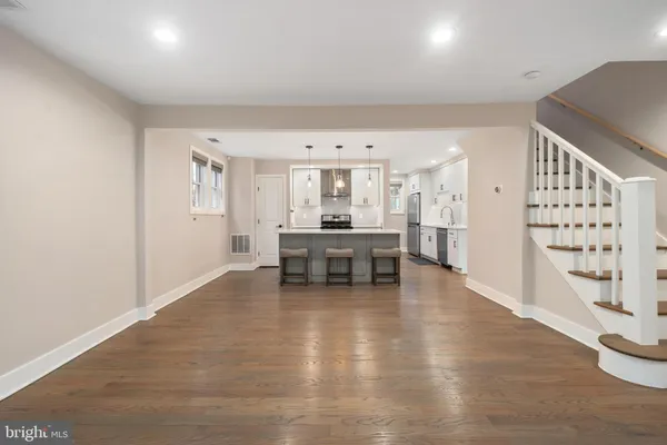 a living room with furniture and kitchen view