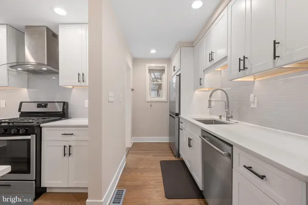 a kitchen with a sink stove and refrigerator
