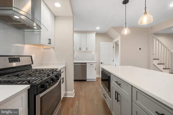 a kitchen with a stove a sink and a refrigerator
