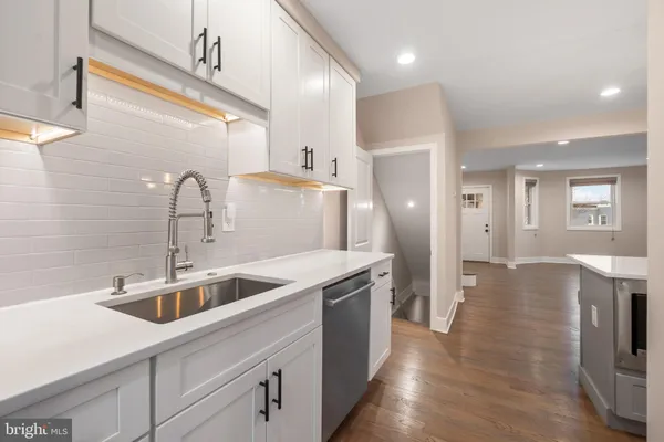 a kitchen with a sink and refrigerator