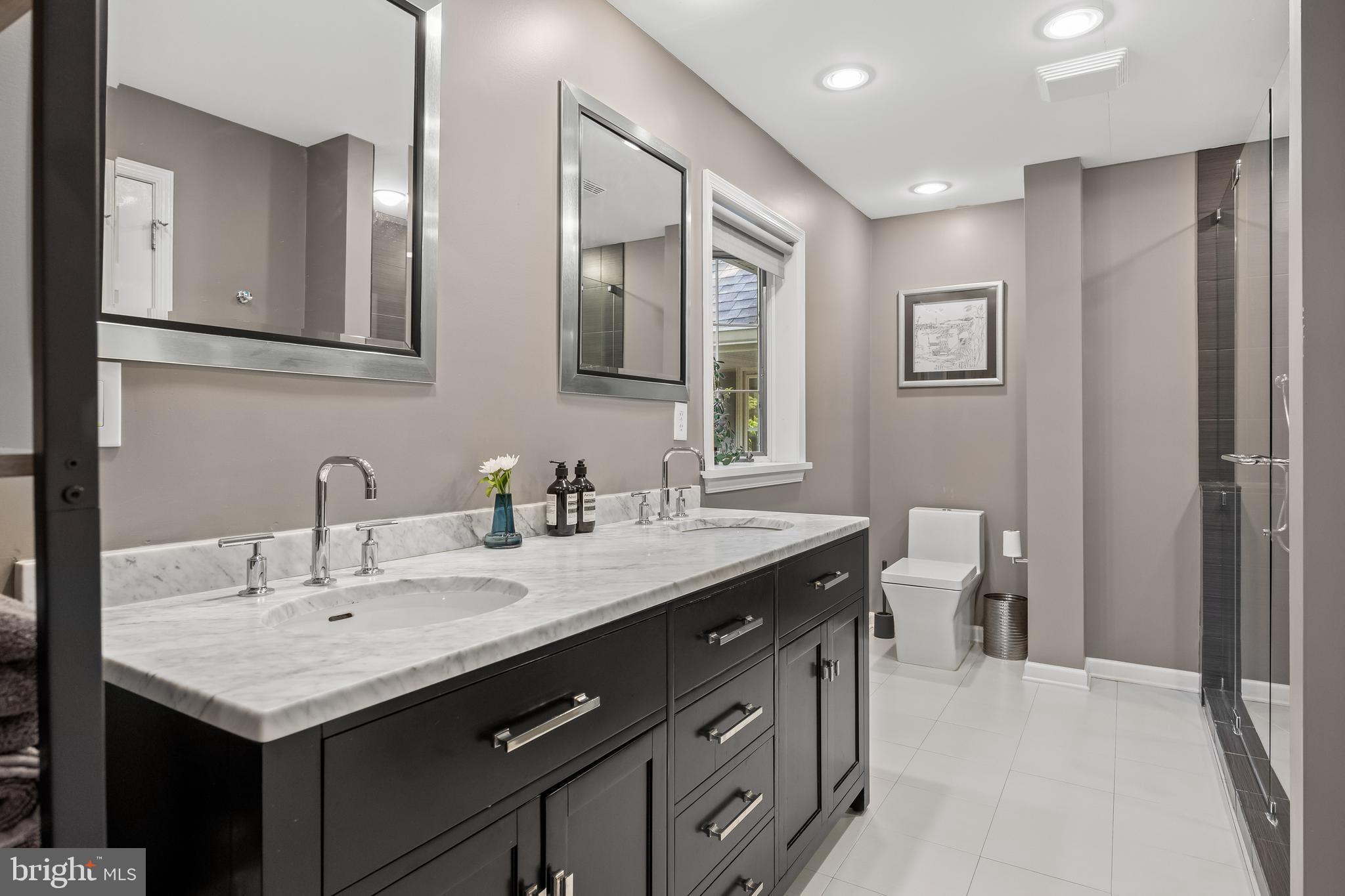 4 Rooftree Road Cherry Hill, NJ 08003 - Photo 19 of 42 a bathroom with a granite countertop sink a large mirror and a toilet