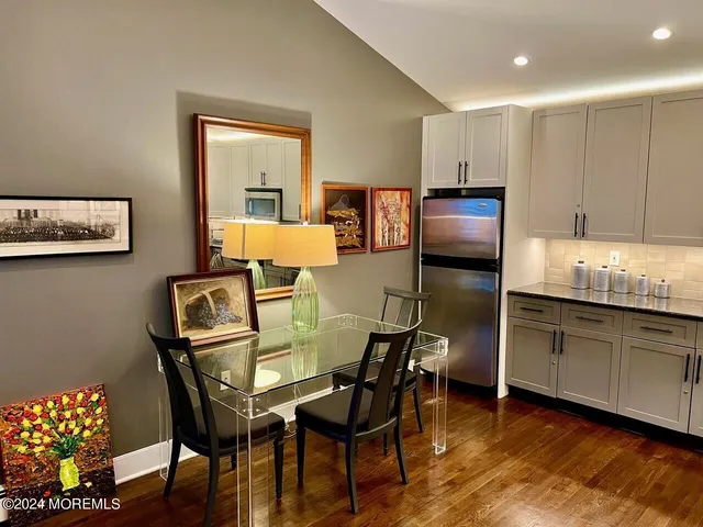 a dining room with furniture and wooden floor