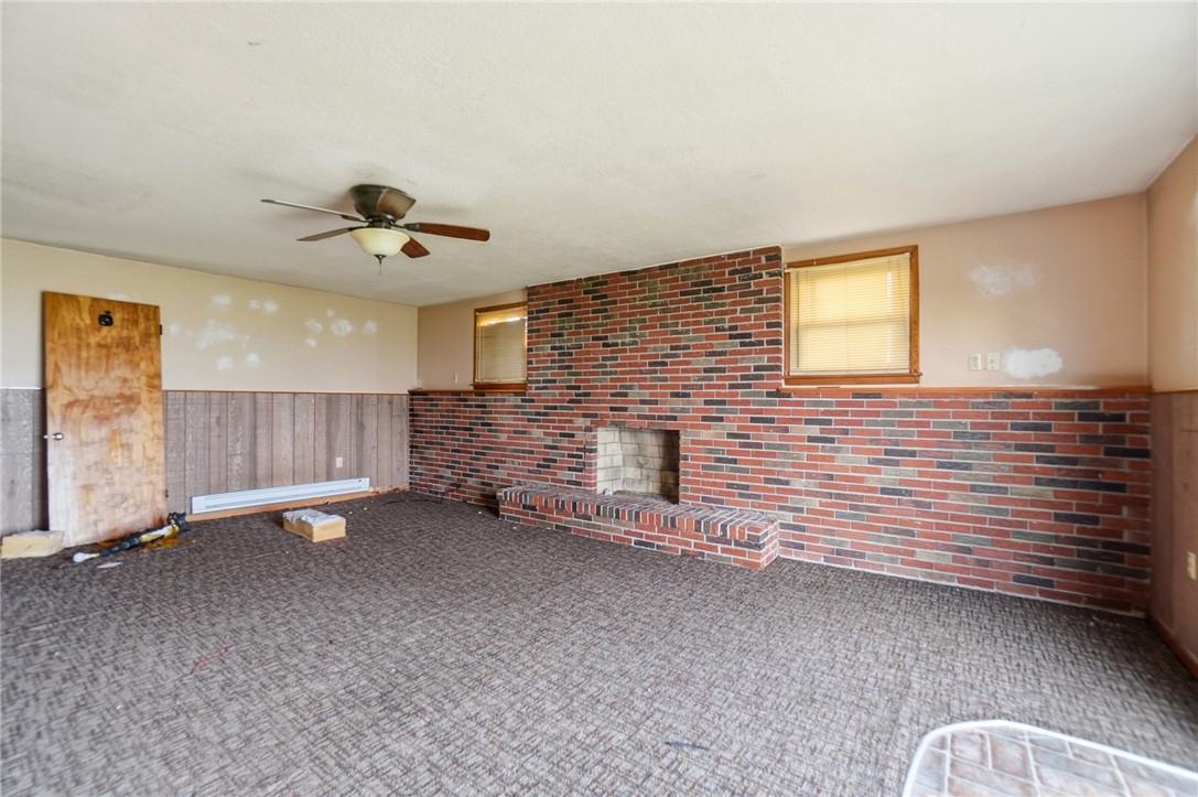 9750 Middlepoint Road Middle Point, OH 45863 - Photo 26 of 43 This living area features a brick fireplace, creating a cozy and inviting atmosphere.