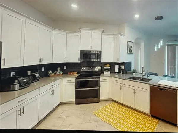 a kitchen with stainless steel appliances granite countertop a sink and cabinets