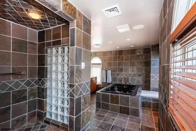 a bathroom with a sink a bathtub and shower