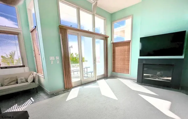 a dining hall with granite countertop a stove a sink a dining table and chairs