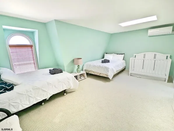 a bedroom with furniture and a flat screen tv