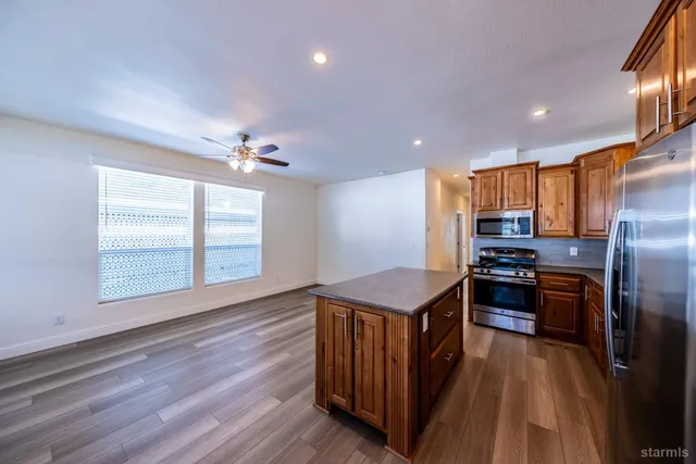 a kitchen with stainless steel appliances granite countertop a stove and a refrigerator