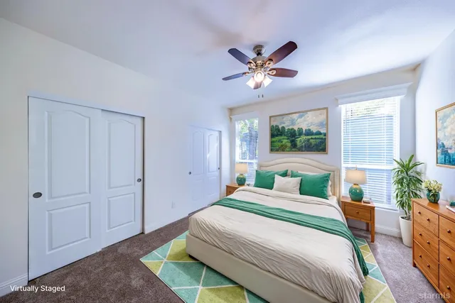 a bedroom with a large bed and a chandelier