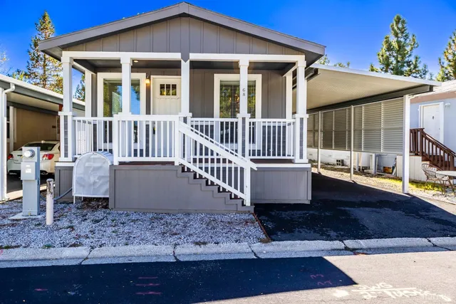 a view of a house with a yard and wooden floor