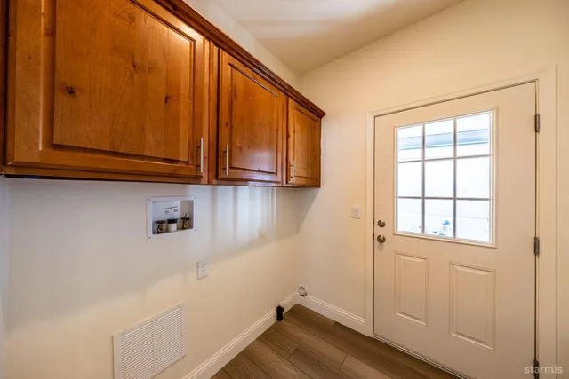 a view of storage and utility room with wooden floor