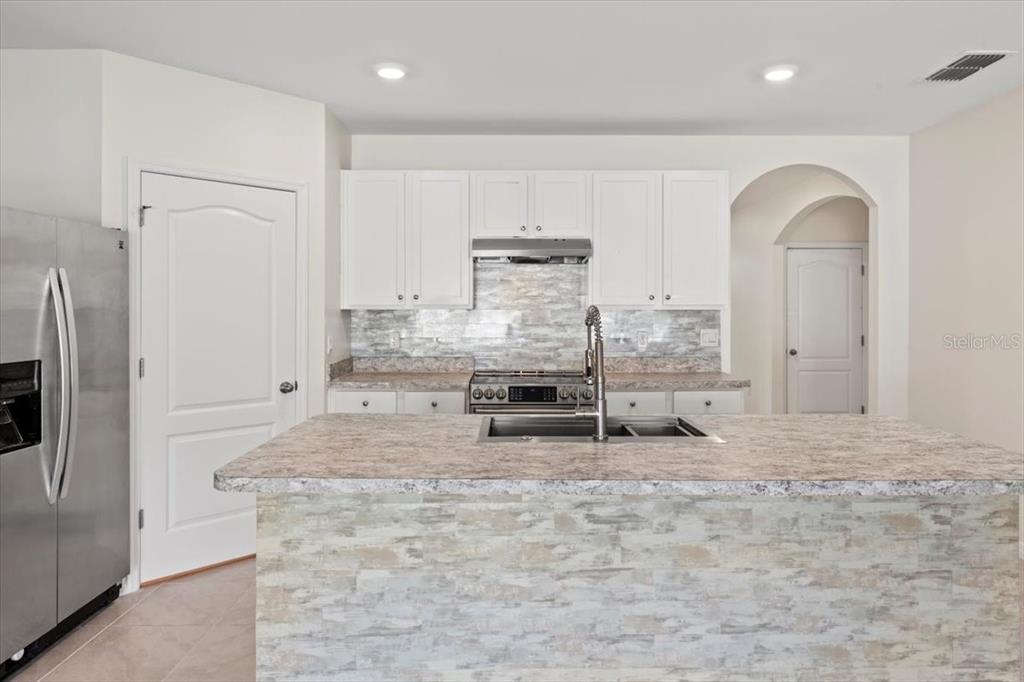 205 Old Mill Pond Road Palm Harbor, FL 34683 - Photo 18 of 57 a view of kitchen and living room
