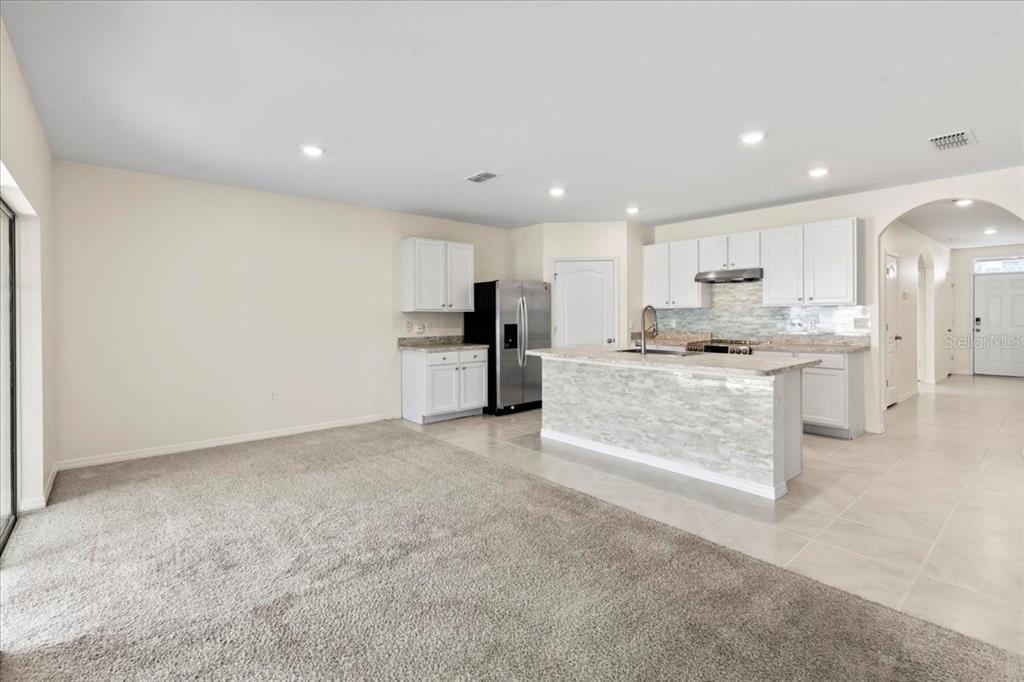 205 Old Mill Pond Road Palm Harbor, FL 34683 - Photo 19 of 57 a large kitchen with cabinets and a counter top space
