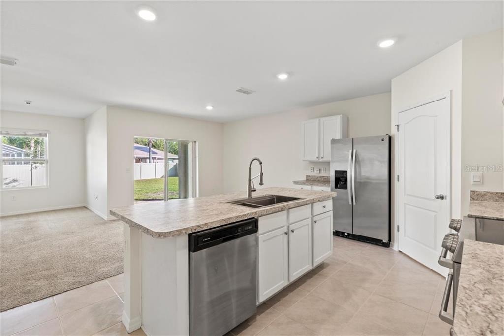 205 Old Mill Pond Road Palm Harbor, FL 34683 - Photo 20 of 57 a kitchen with a sink stove and refrigerator