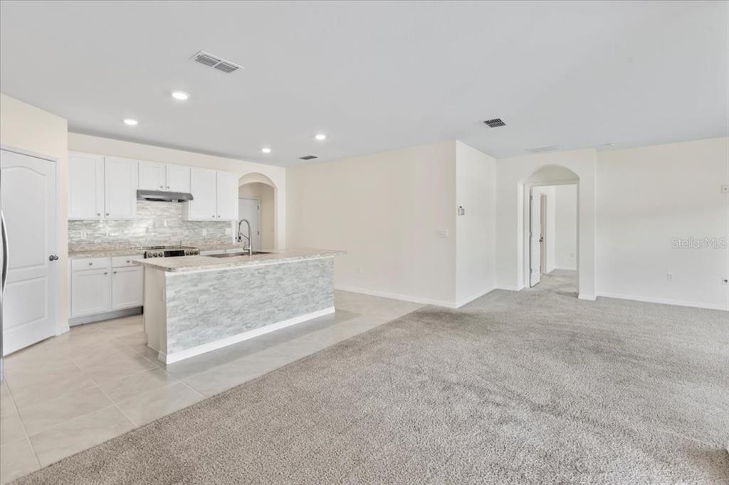 205 Old Mill Pond Road Palm Harbor, FL 34683 - Photo 23 of 57 a kitchen with stainless steel appliances granite countertop a stove a sink and a refrigerator