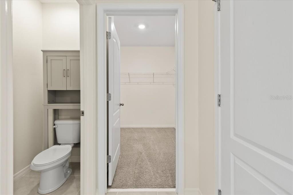 205 Old Mill Pond Road Palm Harbor, FL 34683 - Photo 33 of 57 a bathroom with a granite countertop toilet and a shower