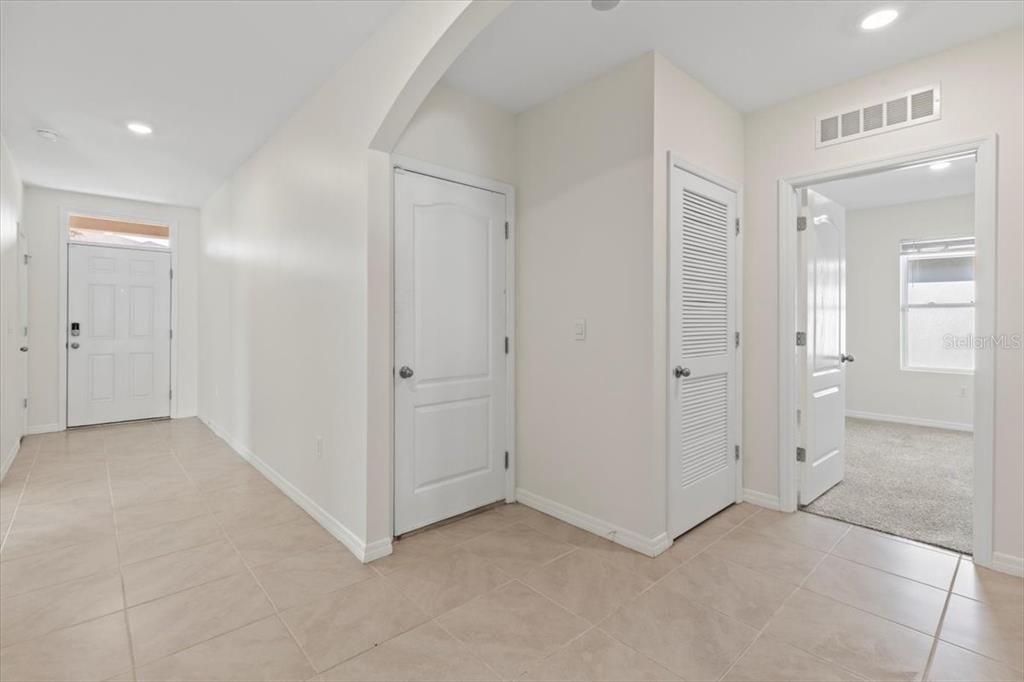 205 Old Mill Pond Road Palm Harbor, FL 34683 - Photo 4 of 57 an empty room with white cabinet and mirror