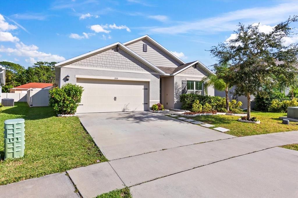 205 Old Mill Pond Road Palm Harbor, FL 34683 - Photo 44 of 57 a front view of house with yard and green space