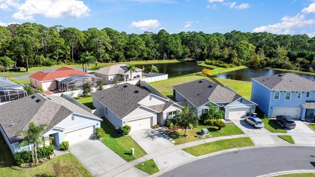 205 Old Mill Pond Road Palm Harbor, FL 34683 - Photo 47 of 57 an aerial view of a house with a garden and lake view