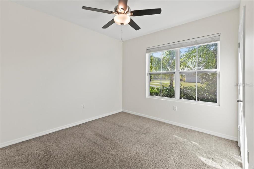 205 Old Mill Pond Road Palm Harbor, FL 34683 - Photo 5 of 57 an empty room with a window and a fan