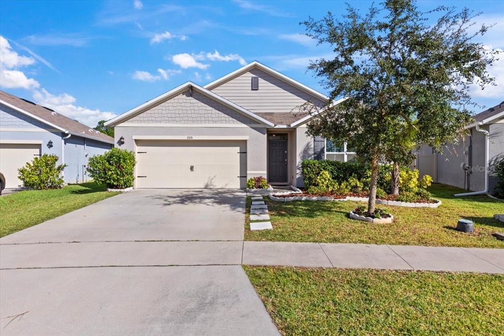 205 Old Mill Pond Road Palm Harbor, FL 34683 - Photo 55 of 57 a front view of a house with garden