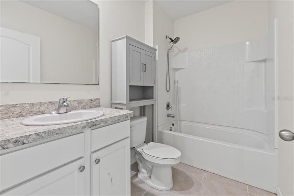 205 Old Mill Pond Road Palm Harbor, FL 34683 - Photo 8 of 57 a bathroom with a granite countertop sink toilet and shower