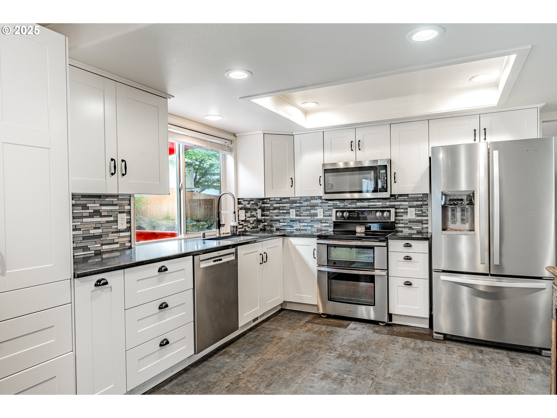 4043 Southeast Harmony Place Camas, WA 98607 - Photo 11 of 40 a kitchen with stainless steel appliances a refrigerator sink and cabinets