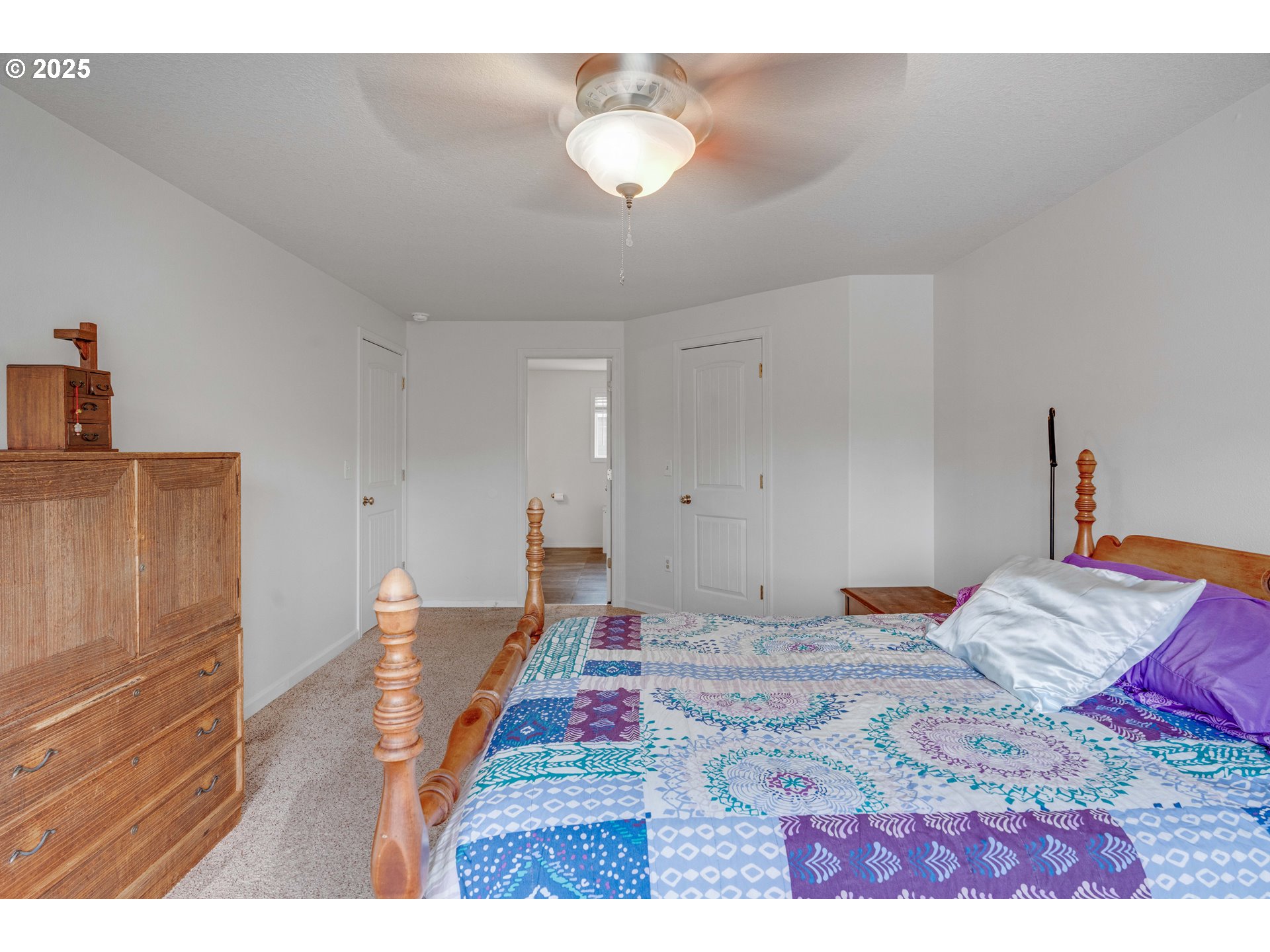 4043 Southeast Harmony Place Camas, WA 98607 - Photo 27 of 40 a bedroom with a bed and a lamp