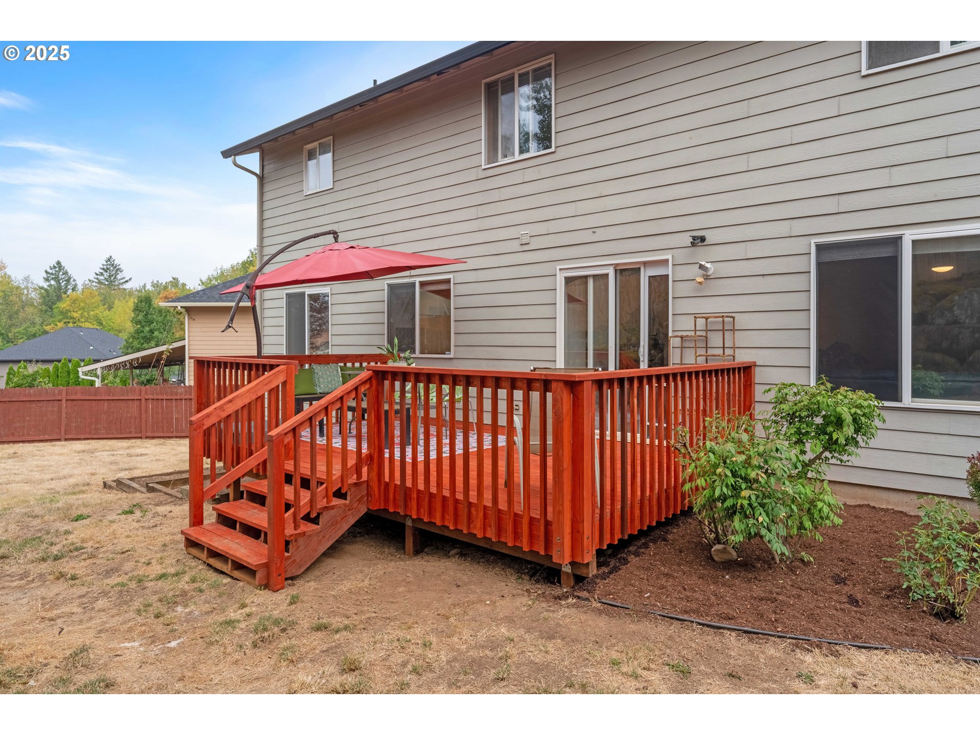 4043 Southeast Harmony Place Camas, WA 98607 - Photo 32 of 40 a view of a house with wooden deck and furniture
