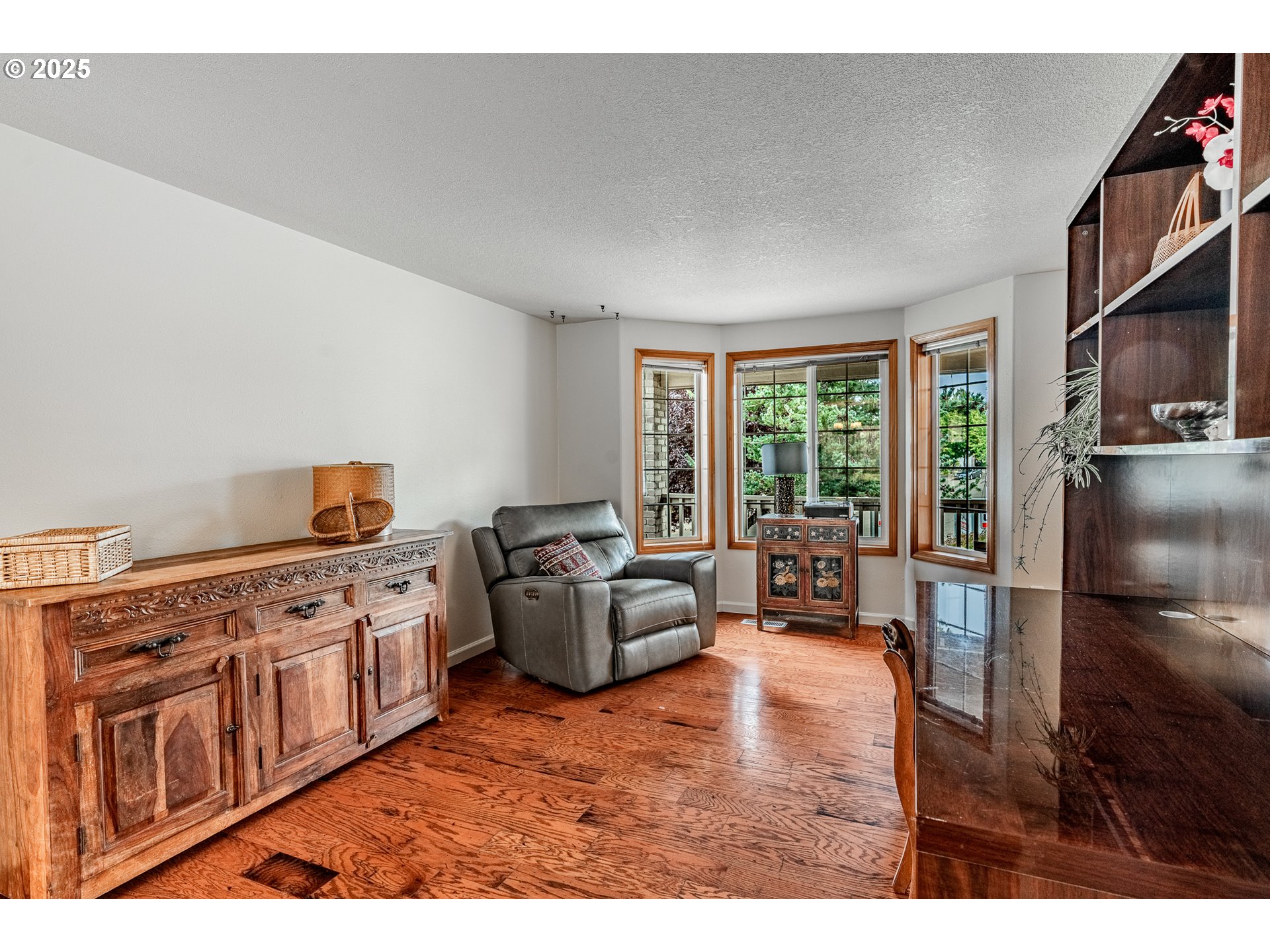 4043 Southeast Harmony Place Camas, WA 98607 - Photo 4 of 40 a living room with furniture a flat screen tv and a floor to ceiling window