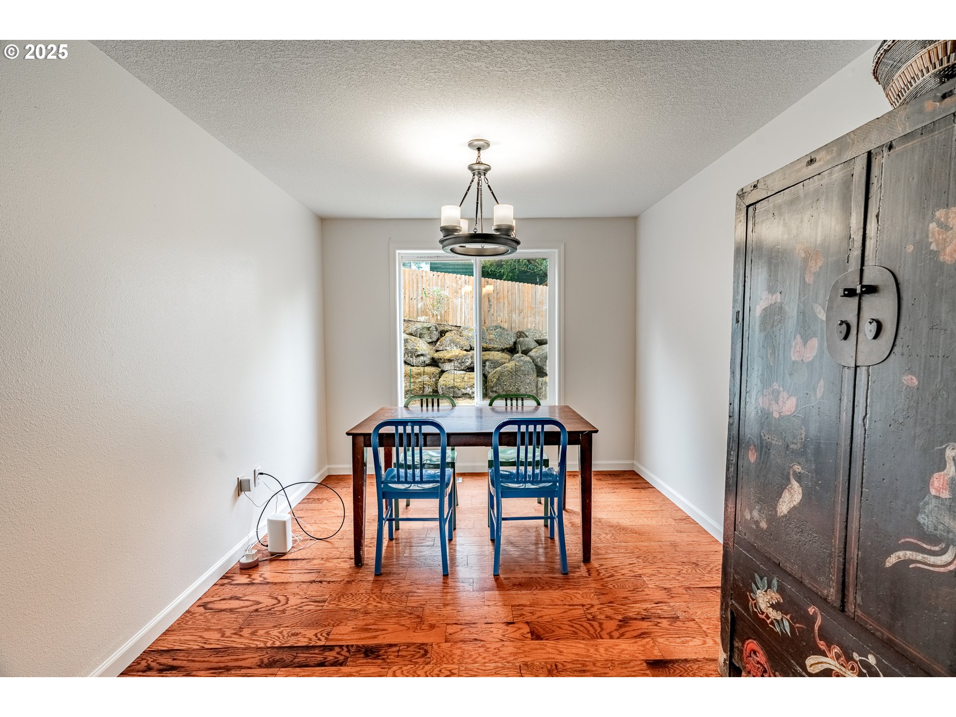 4043 Southeast Harmony Place Camas, WA 98607 - Photo 7 of 40 a dining room with furniture a chandelier and wooden floor