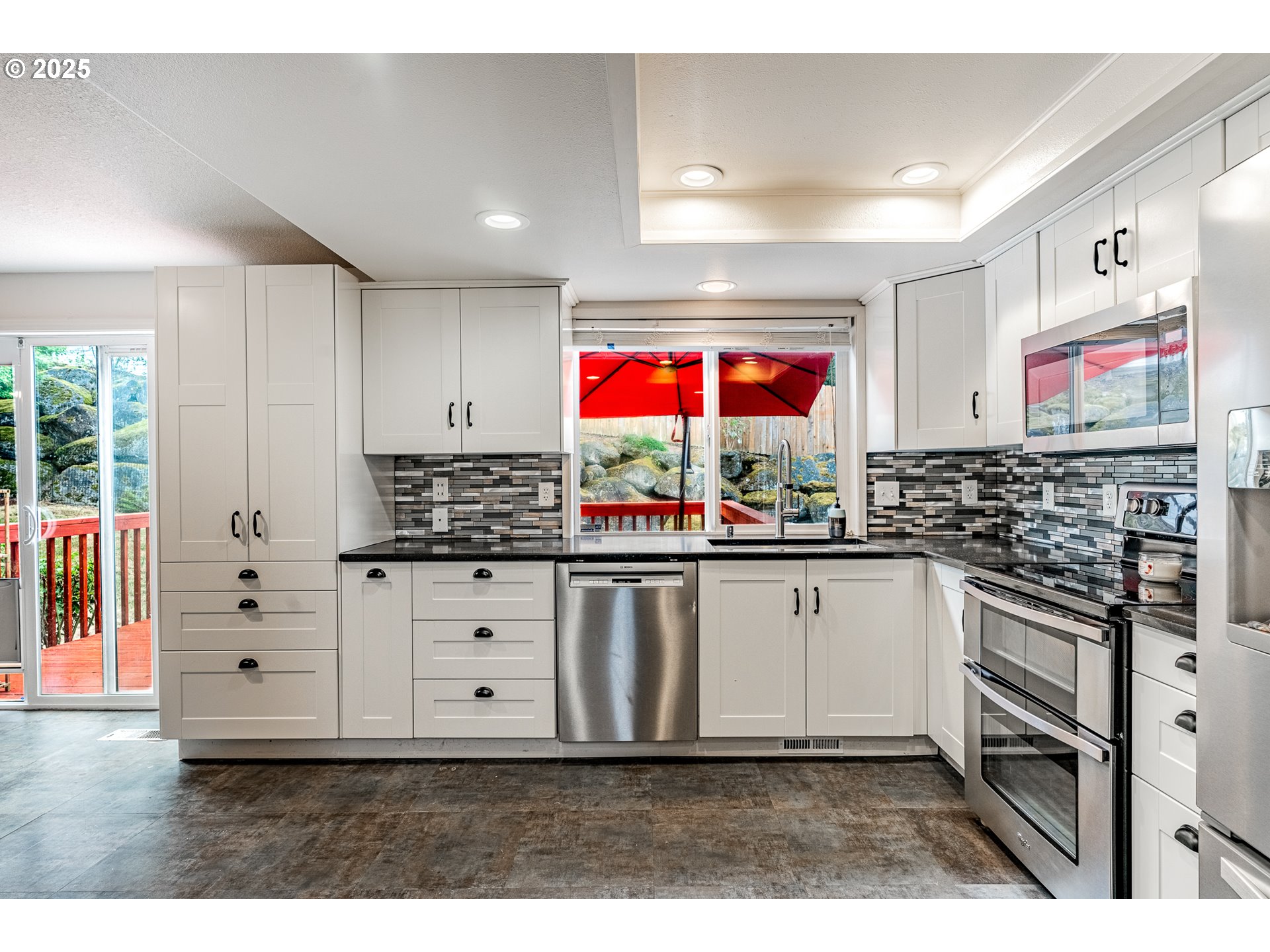 4043 Southeast Harmony Place Camas, WA 98607 - Photo 10 of 40 a kitchen with stainless steel appliances kitchen island granite countertop a sink and cabinets