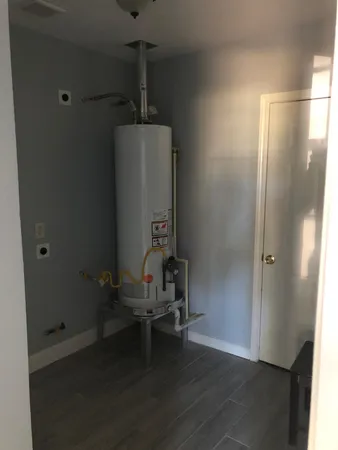 a view of a room with gym equipment and wooden floor