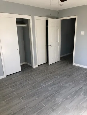 an empty room with wooden floor and closet