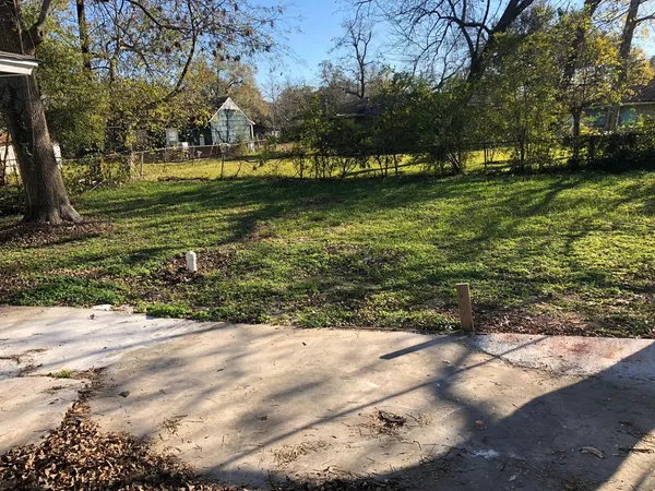 a view of yard with swimming pool and green space