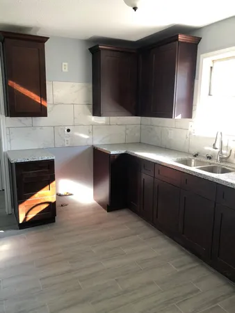 a kitchen with stainless steel appliances a sink dishwasher a stove a microwave and cabinets