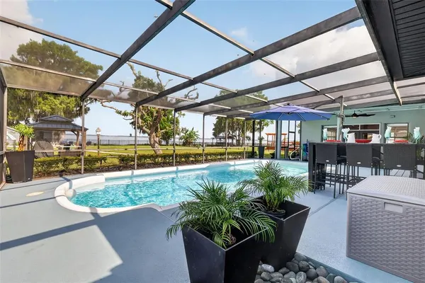 a view of a swimming pool with outdoor seating