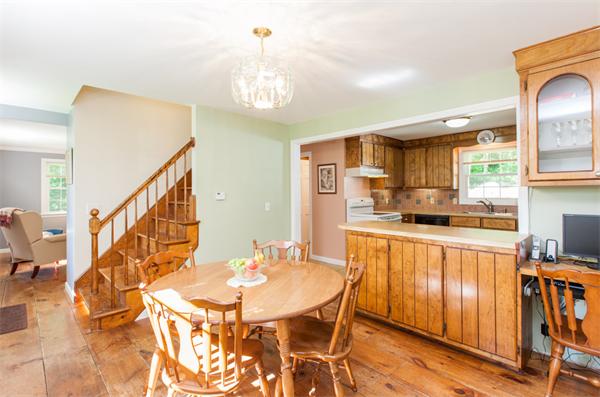 224 Munn Road Monson, MA 01057 - Photo 14 of 30 a kitchen with stainless steel appliances kitchen island granite countertop a table chairs and a chandelier