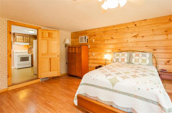 224 Munn Road Monson, MA 01057 - Photo 20 of 30 a bedroom with a bed and wooden floor