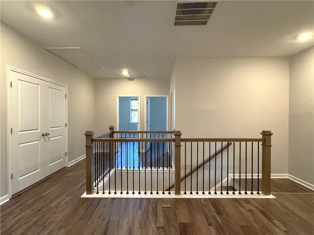 a view of hallway with wooden floor