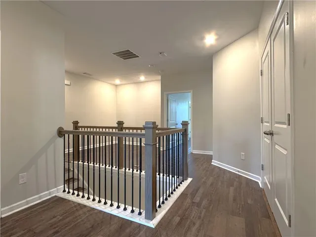 a view of hallway with wooden floor