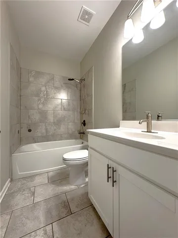 a bathroom with a bathtub a sink a toilet and a mirror