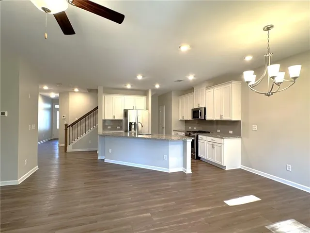 a view of kitchen with cabinets and wooden floor