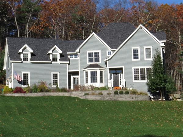 a front view of house with yard and green space