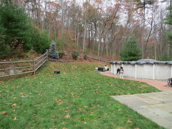 14 Corn Road Bolton, MA 01740 - Photo 21 of 22 a backyard of a house with a yard and outdoor seating