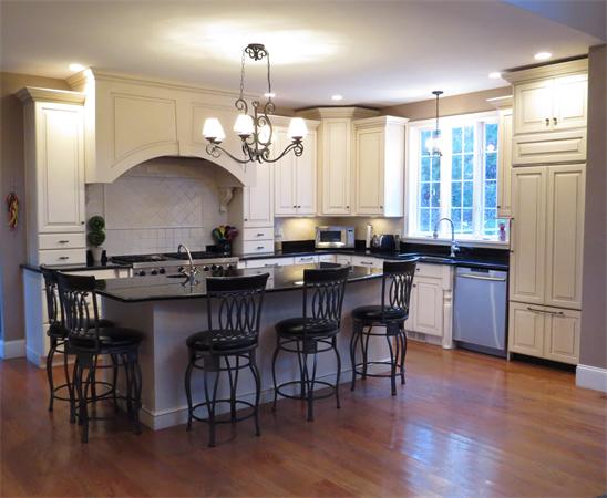 14 Corn Road Bolton, MA 01740 - Photo 5 of 22 a kitchen with stainless steel appliances granite countertop a stove a refrigerator a sink a dining table and chairs with wooden floor