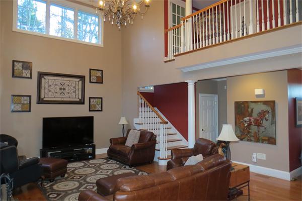 14 Corn Road Bolton, MA 01740 - Photo 9 of 22 a living room with furniture a flat screen tv and a fireplace